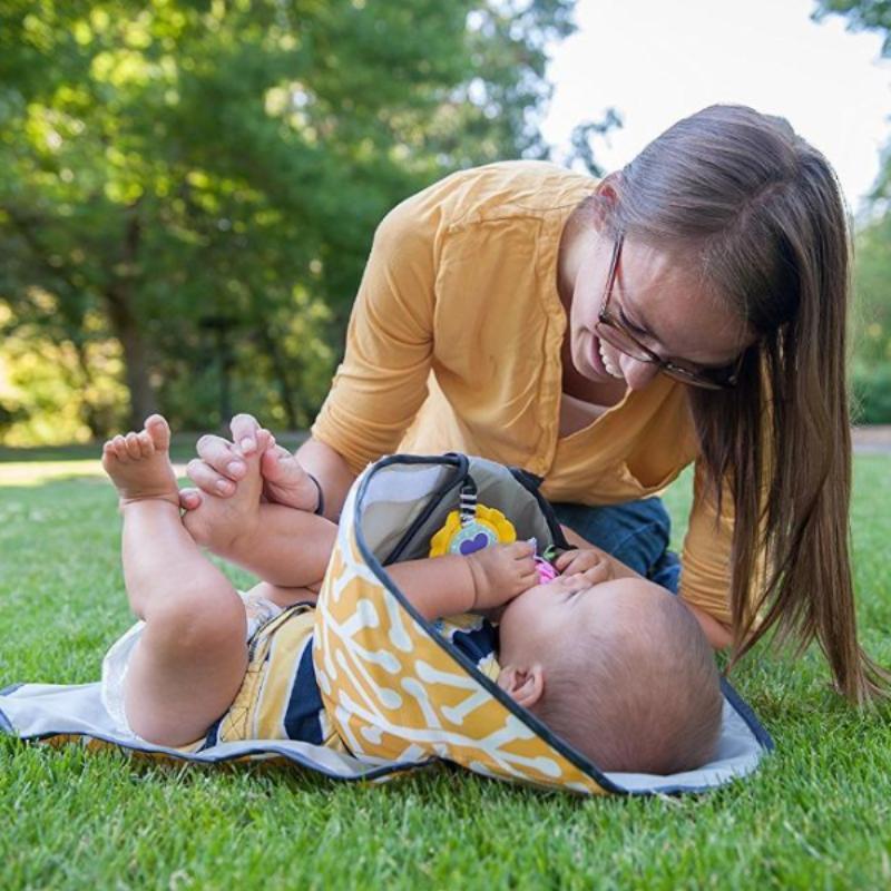 Happy mom after changing baby diapers