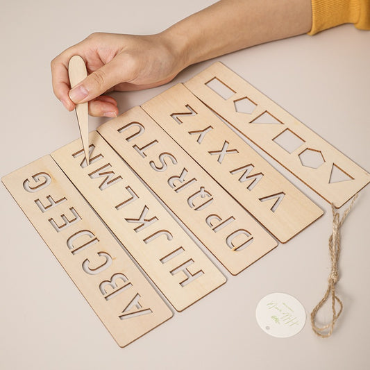 Girl practicing writing on tracing board for kids