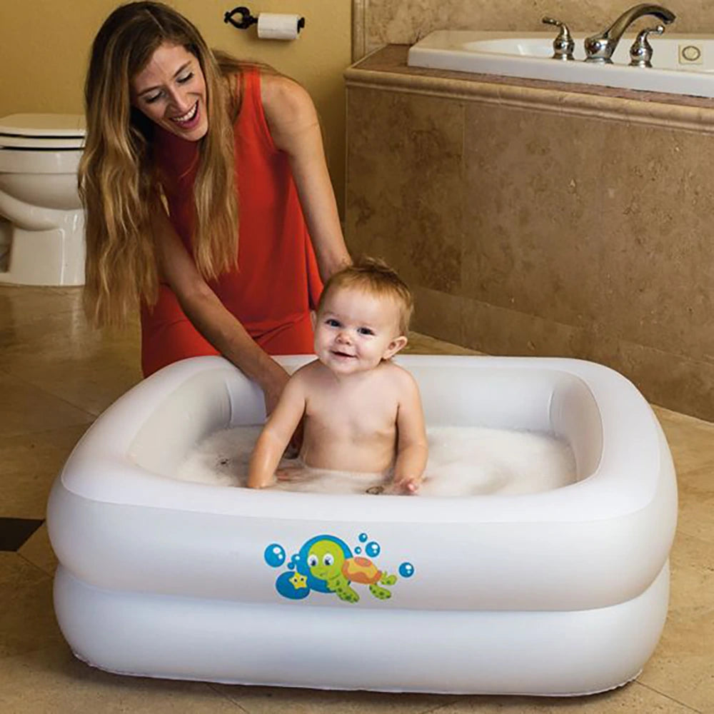 mom baby in white inflatable baby bath tub